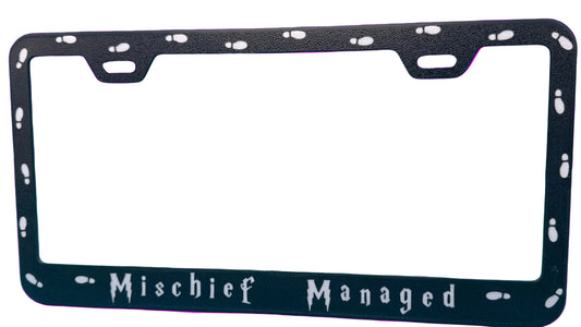 Black license plate frame with 'Mischief Managed' text on a white background